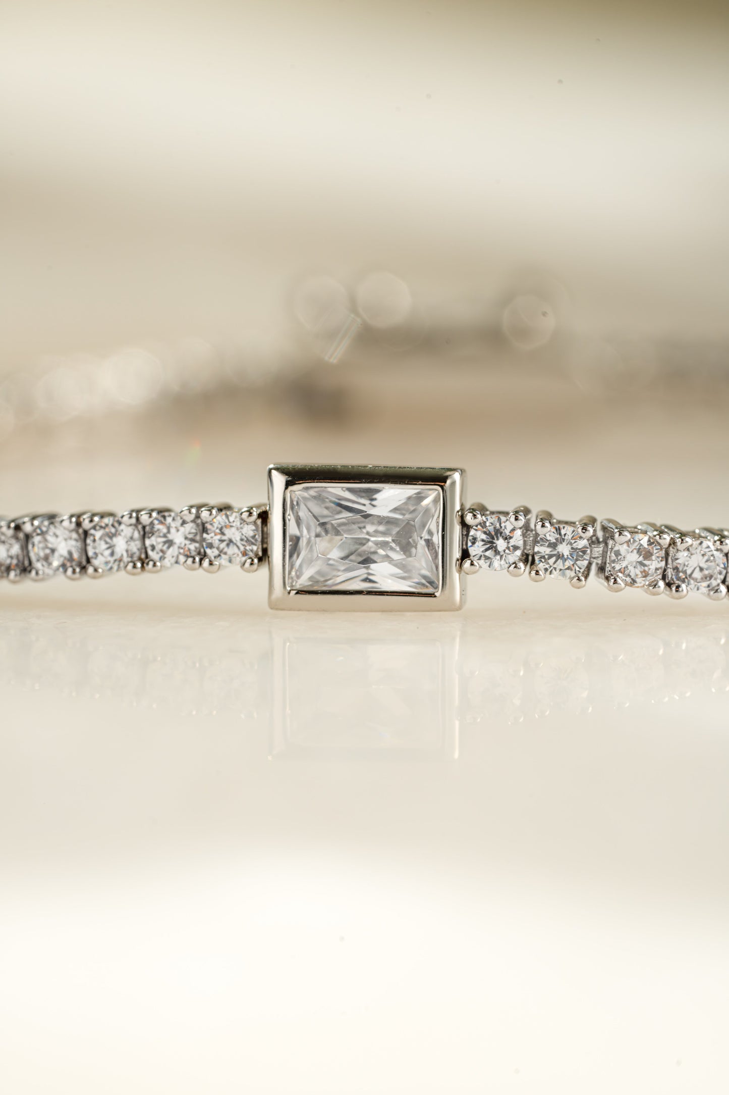 Bezeled Emerald-Cut Charm Tennis Bracelet
